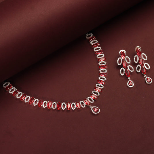 Rhodium Plated Elegant Necklace Set With Ruby Color Stones And Pair Of Earrings