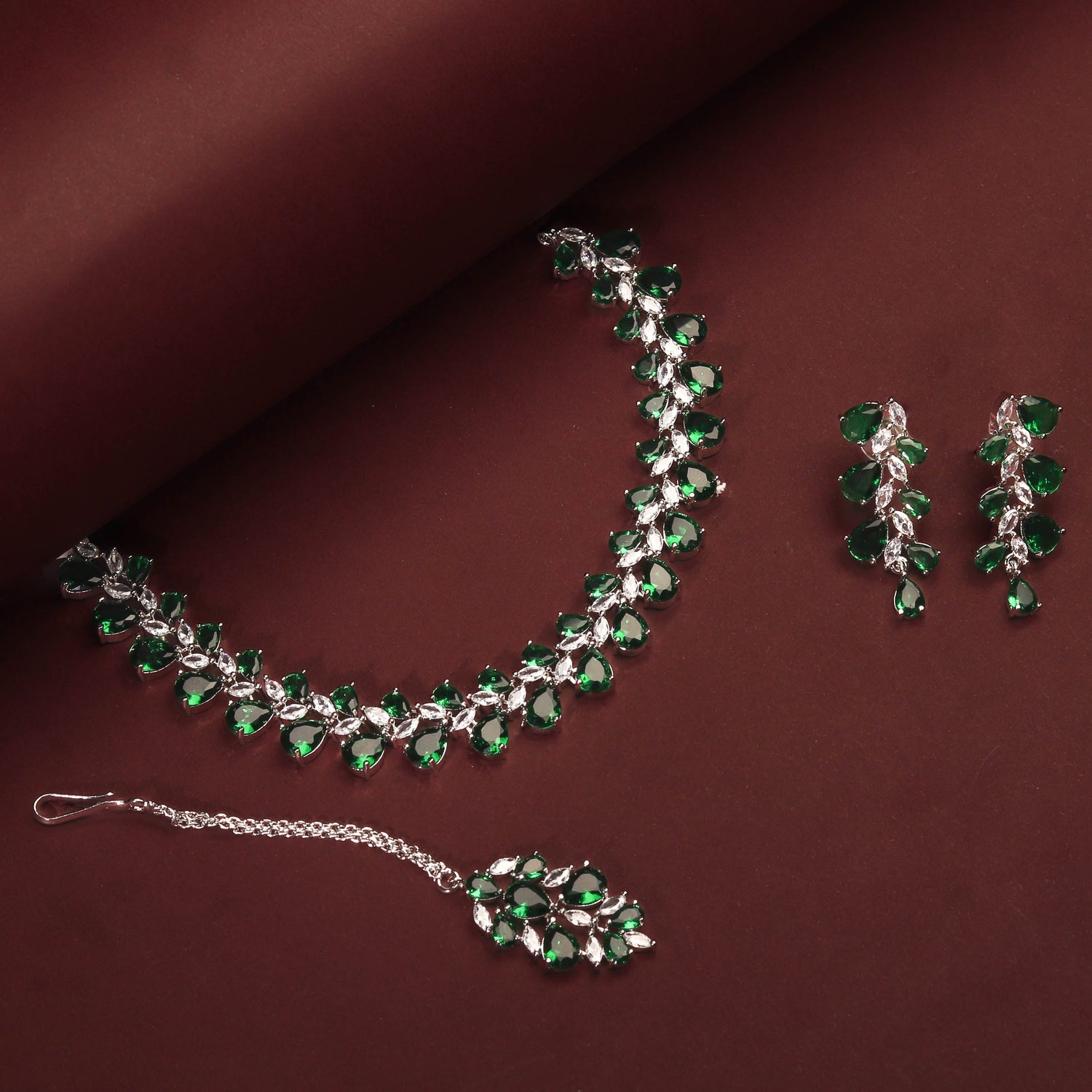 Rhodium Plated Luxurious Emerald Green Color Necklace Set With Earrings And Maang Tikka